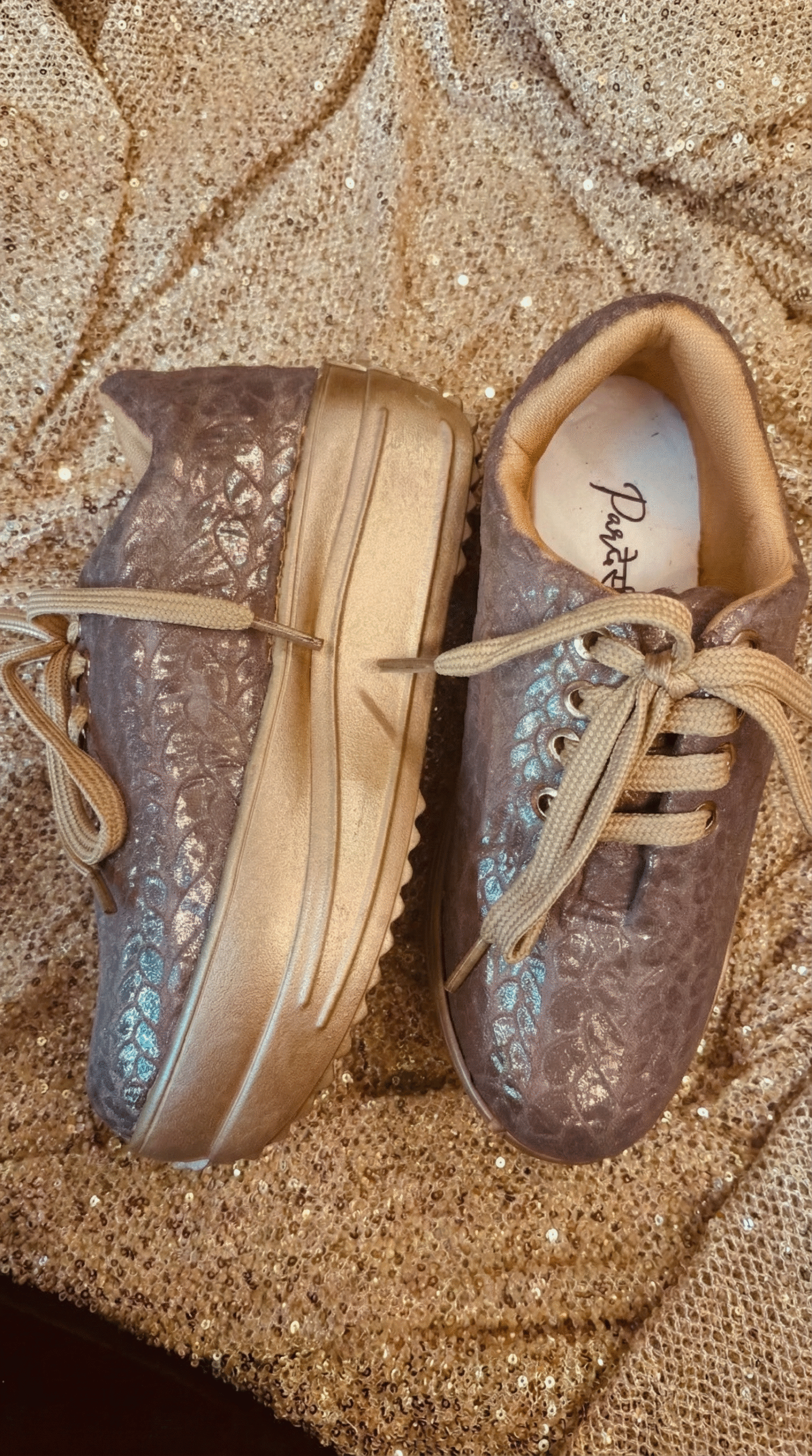 Firefly_Gemini Flash_Create an image for my website of the sneakers in the reference image with gold shimm 249398