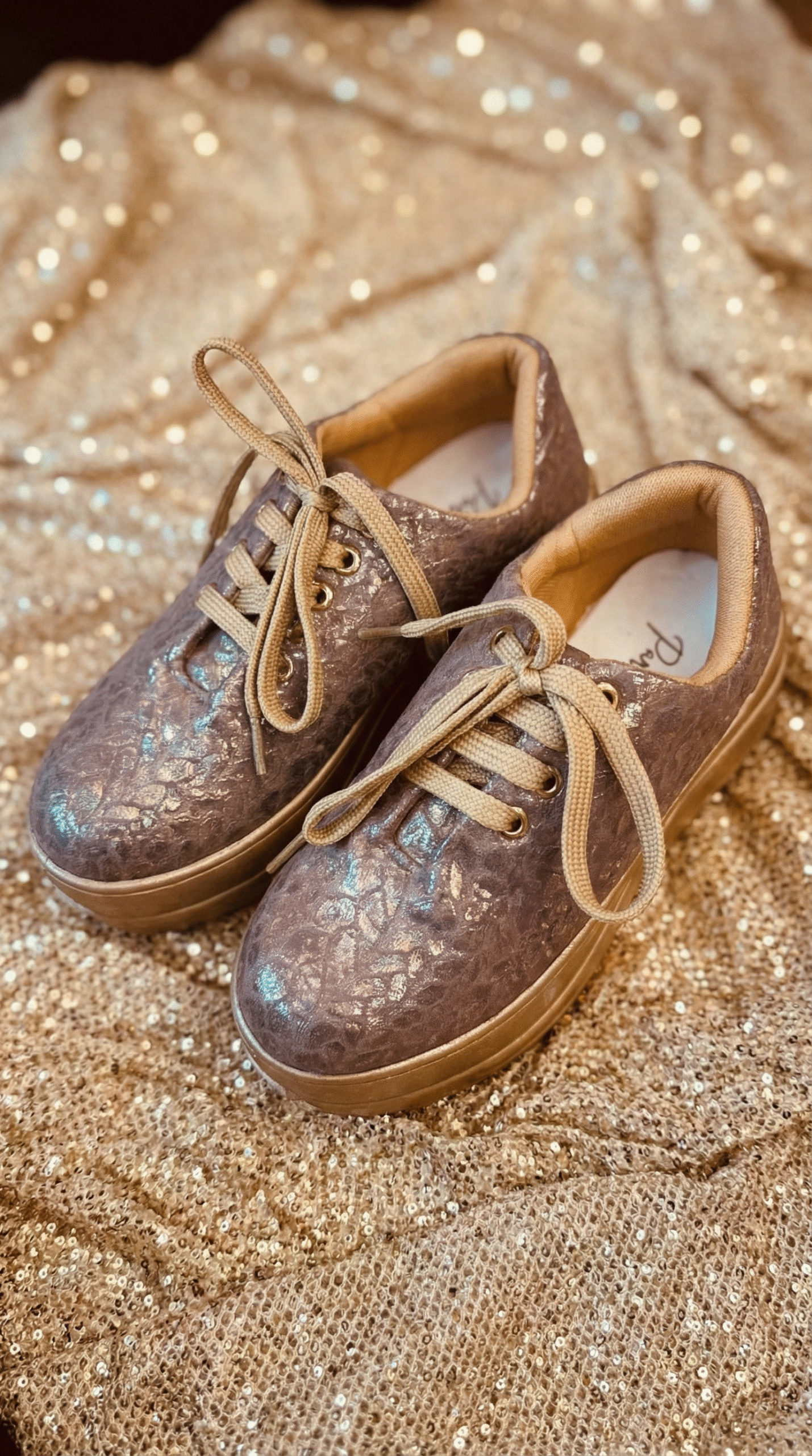 Firefly_Gemini Flash_Create an image for my website of the sneakers in the reference image with gold shimm 448628