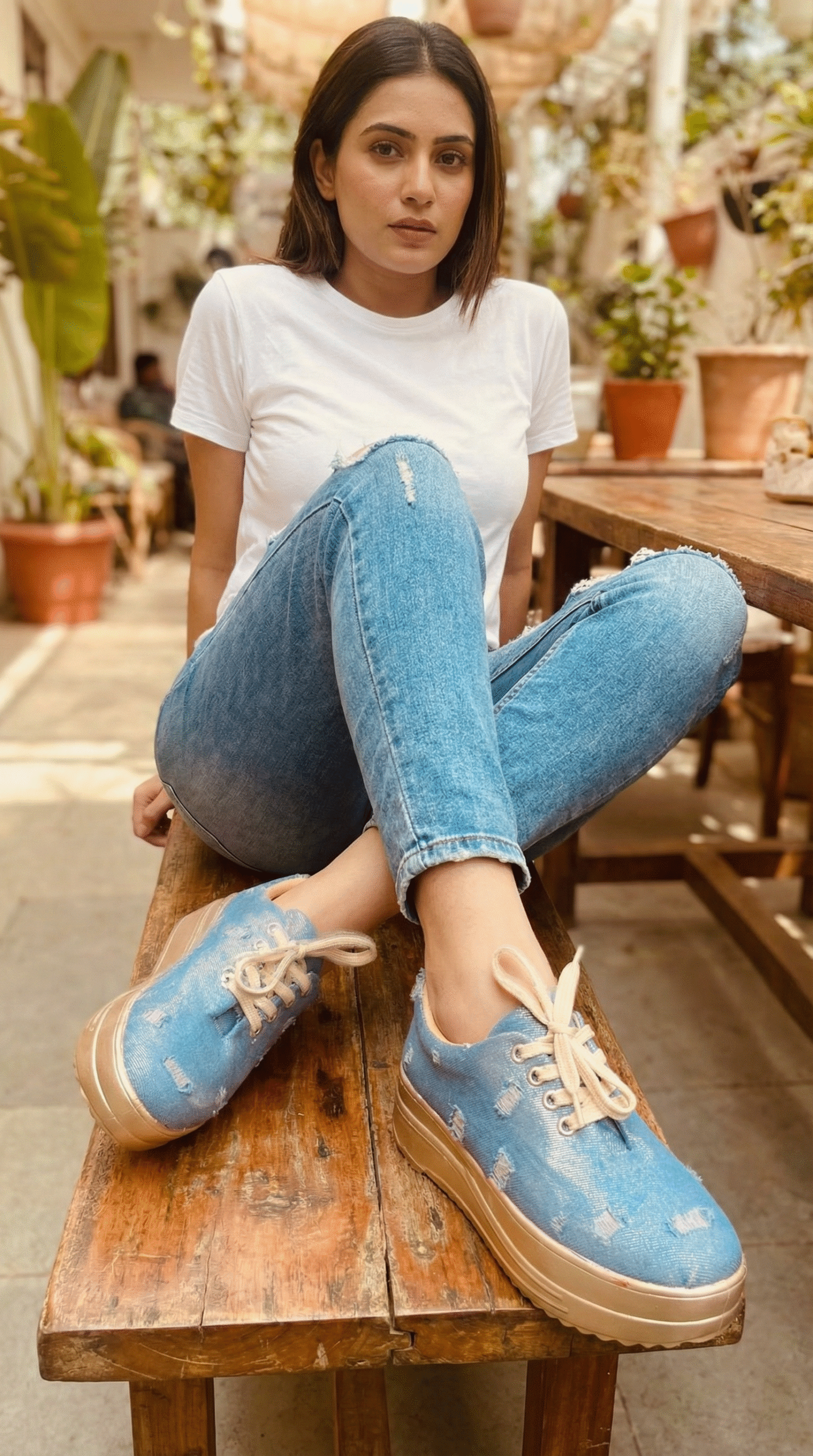 Firefly_Gemini Flash_Create an image in which a model is wearing white tshirt and jeans with sneakers in t 810556